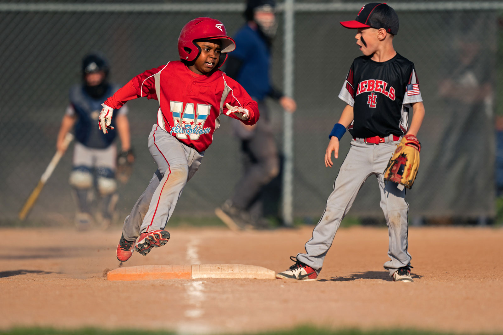 A young player with Jackie Robinson West runs the bases during the Little League game against the New Lennox Rebels, at the Tyler-Bentley Field Complex in New Lennox, Illinois