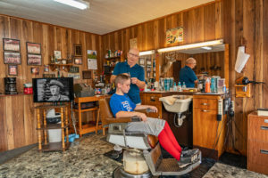 Nolan Commons, a young player with the Pro Treaders, gets his haircut by Sonny Dinger, at Sonny's Barbershop on September 16, 2020 in Baxter Springs, Kansas